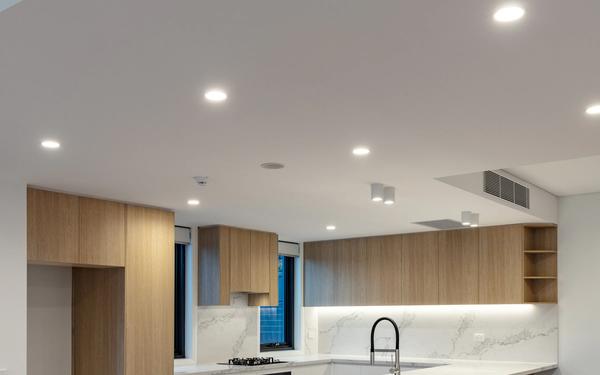 A kitchen and living area lit with new LED downlights