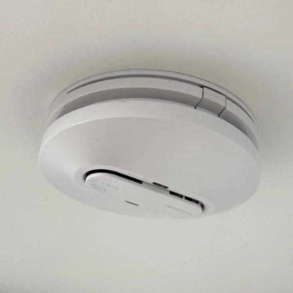 A new 240 V smoke alarm fitted to the ceiling